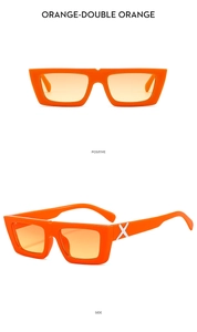 Detail view of orange square sunglasses with gradient lenses and white X logo on temple