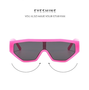 Pink oversized shield sunglasses with jelly frame and dark grey lenses in macro view