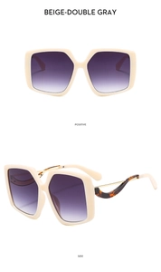 Detail of beige butterfly frame sunglasses with purple gradient lenses and metal temples