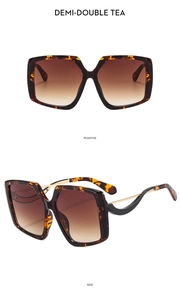 Detail of oversized square tortoiseshell sunglasses with gradient tea lenses and gold hinges