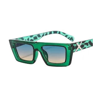 Green square frame sunglasses with blue-orange gradient lenses and leopard patterned temples
