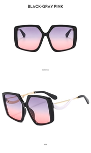 Detail view of butterfly oversized sunglasses with gradient lenses and hollowed metal temples