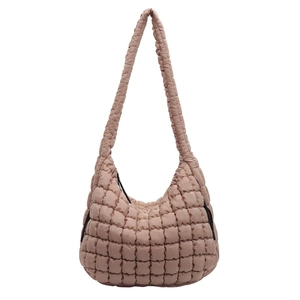 Detailed view of the quilted texture and structure of the pink bubble shoulder bag