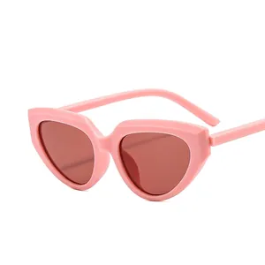 Pink Y2K cat-eye sunglasses with thick temples and translucent brownish red lenses