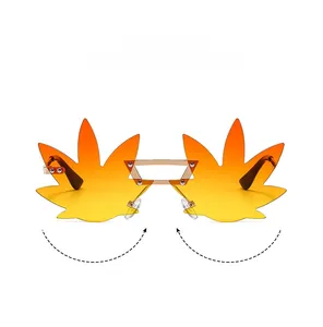Detail view of rimless maple leaf sunglasses with gradient yellow lenses and metal bridge