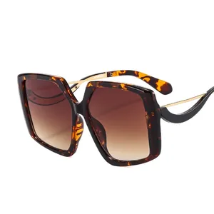 Oversized tortoise shell butterfly sunglasses with brown gradient lenses and gold metal temples