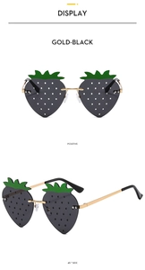 Gros plan de lunettes de soleil fraise sans monture en or et noir avec tiges en métal