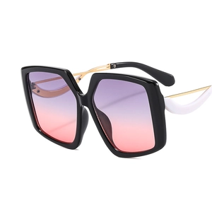 Oversized butterfly sunglasses with black white frame and purple gradient lenses