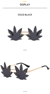 Macro view of gold metal frames and black maple leaf shaped lenses on rimless sunglasses