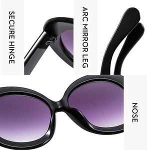 Detail view of reinforced hinge and curved temples on round frame sunglasses