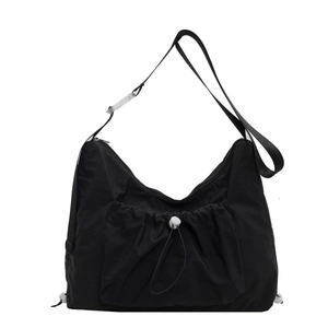 Minimalist black nylon crossbody bag with drawstring pocket for casual summer style