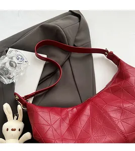 Close-up of red PU crossbody bag featuring unique 3D geometric triangular pattern
