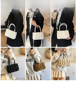Close-up of pleated cloud bags in white black and brown colors with soft leather texture