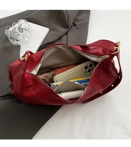 Detailed interior of red geometric shoulder bag showing large capacity for essentials