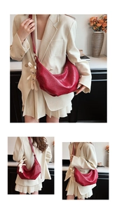Detail of red geometric quilted dumpling bag with a cute white plush rabbit charm