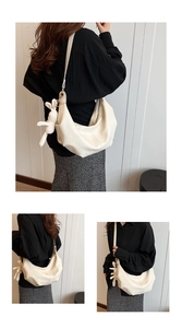 Detail of off-white crescent crossbody bag with geometric quilting and plush rabbit charm