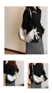 Close-up of silver hobo bag with geometric quilting and a cute white bunny pendant