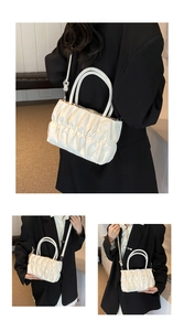 Detailed views of white ruched cloud bag showing soft faux leather texture and dual straps