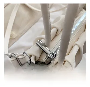 Detailed close-up of premium silver metal hardware and pleated leather texture