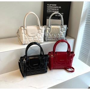 Detailed display of four quilted bucket bags in cream, silver, black, and red colors