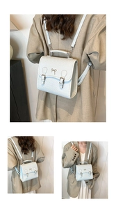 Detailansicht eines weißen Rucksacks mit Webstruktur, Metallbogen und Klappverschluss