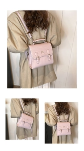 Detail eines rosa Kunstlederrucksacks mit Webstruktur und Bogen-Metallakzent