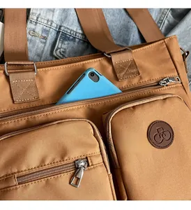 Detail showing vintage tote bag with multiple pockets and a blue tablet storage space
