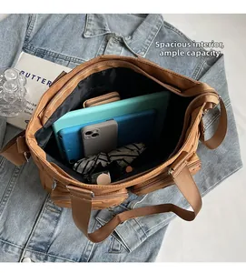 Detailed view of the large capacity interior and multiple pockets of this brown casual tote