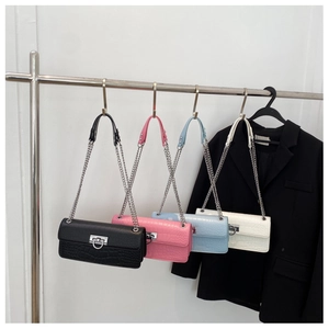 Selection of crocodile pattern flap bags in black, pink, blue, and white with D-buckles