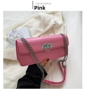 Pink croc-embossed small crossbody bag with silver metal buckle and chain strap detail