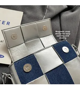 Close-up of wide-weave metallic flap bag featuring a secure dual magnetic buckle closure
