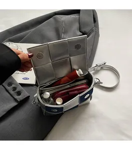 Silver woven crossbody bag detail showing interior capacity with phone and wallet