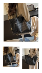Detail of the woven leather texture and spacious interior of the black large tote bag