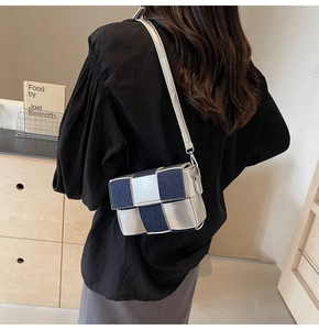 Detailed view of bicolor woven square bag in silver leather and blue denim material