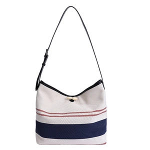 Canvas bucket bag with red and navy stripes, horn toggle closure, and adjustable strap