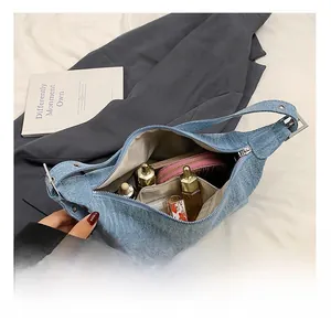Interior view of denim crescent bag showing spacious capacity for daily essentials
