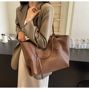 Close-up of brown woven PU leather tote bag with dense crisscross pattern detail