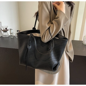 Detail of premium black woven faux leather texture on large capacity tote shoulder bag
