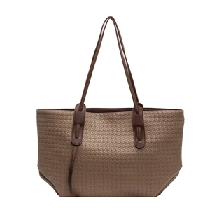 Brown woven PU leather tote bag with long shoulder straps for women on white background
