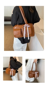 Brown faux leather bowling bag with vintage lace bows and front pocket details
