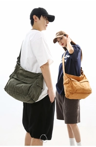 Detail showing vintage canvas messenger bags with multi-pocket design and flap closure