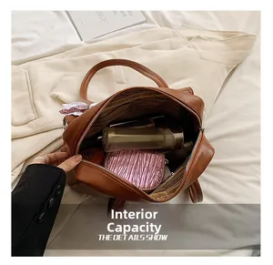 Detail showing the internal capacity and inner lining of this stylish brown PU shoulder bag