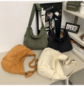 Detailed display of vintage canvas bags in four colors with adjustable wide shoulder straps