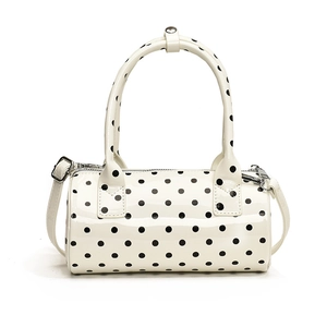 Polka dot white patent leather barrel handbag with silver hardware and shoulder strap