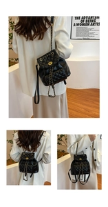 Detailed view of quilted black leather backpack with gold chain straps and turn-lock