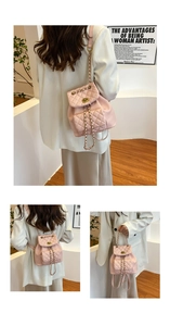 Pink quilted mini backpack with chain straps and detailed embroidery stitching