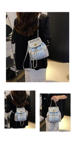 Detail of silver quilted mini backpack featuring gold chain straps and twist-lock closure