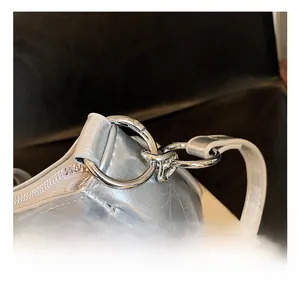 Macro view of metallic silver leather texture with polished round metal swivel hook