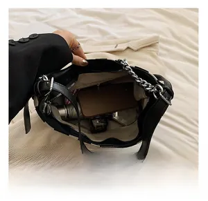 Interior view showing large capacity of the striped shoulder bag with daily items