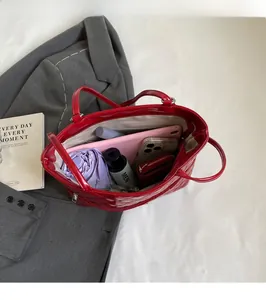 Interior view of red quilted tote bag showing space for tablet, umbrella and wallet